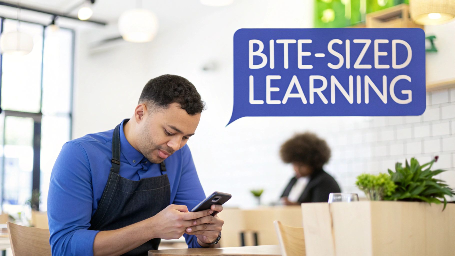 A man in an apron uses his smartphone while a speech bubble reads 'Bite-Sized Learning'.