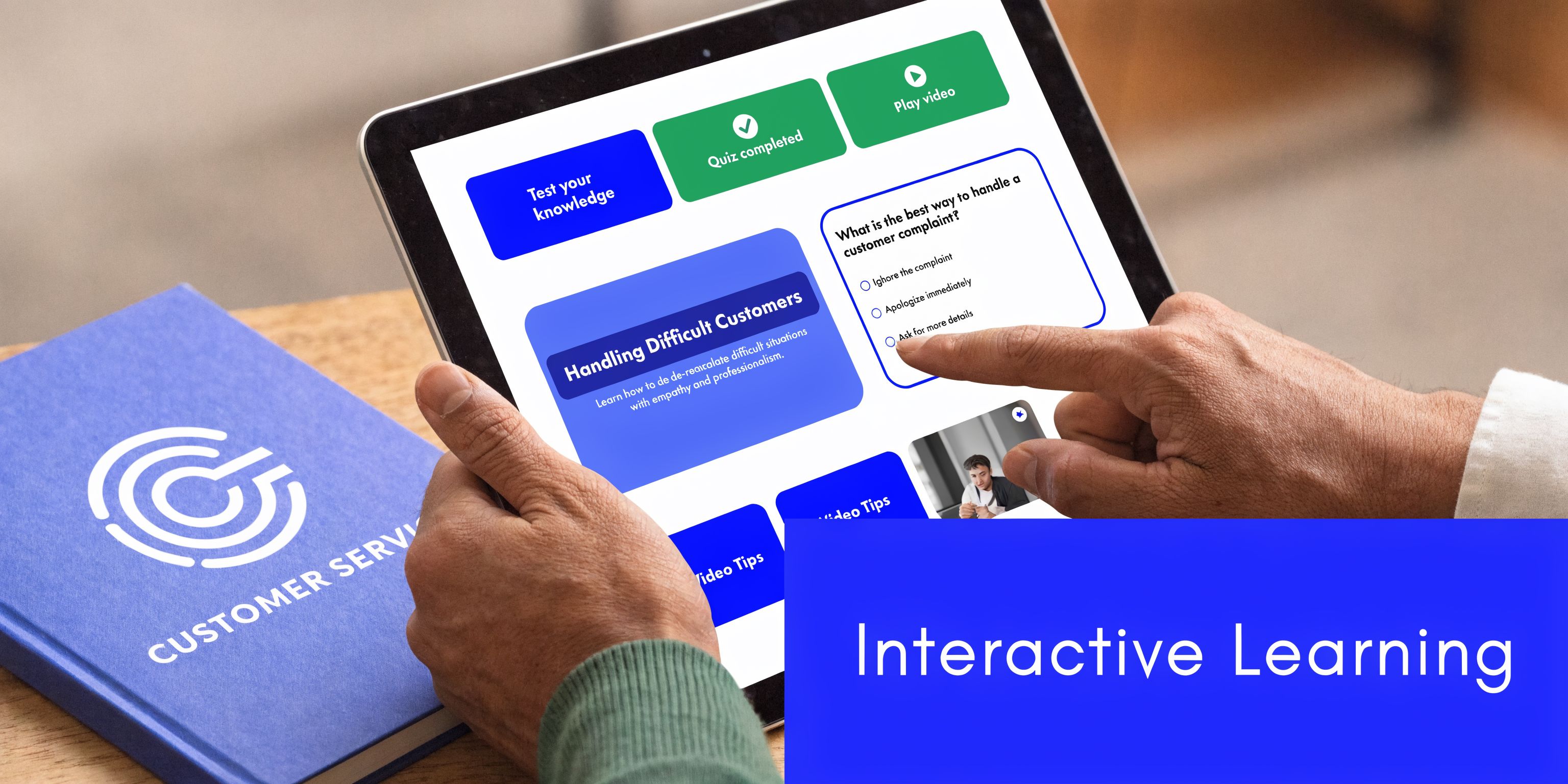 A person using a tablet to complete an interactive customer service training module with a matching workbook nearby.