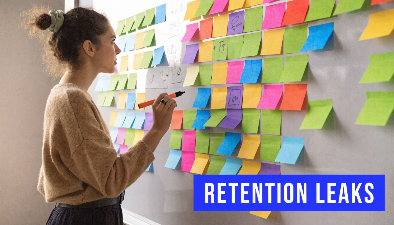 A woman writing on a whiteboard covered with numerous colorful sticky notes while brainstorming ideas.
