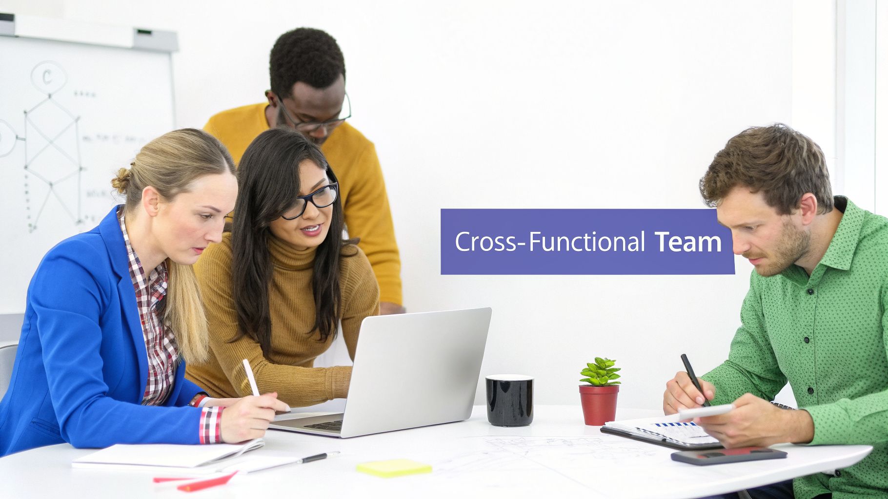 A diverse group of four professionals collaborating and working together in an office setting.